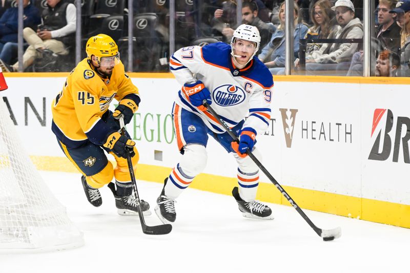 Oct 17, 2024; Nashville, Tennessee, USA;  Edmonton Oilers center Connor McDavid (97) as Nashville Predators defenseman Alexandre Carrier (45) chases during the second period at Bridgestone Arena. Mandatory Credit: Steve Roberts-Imagn Images