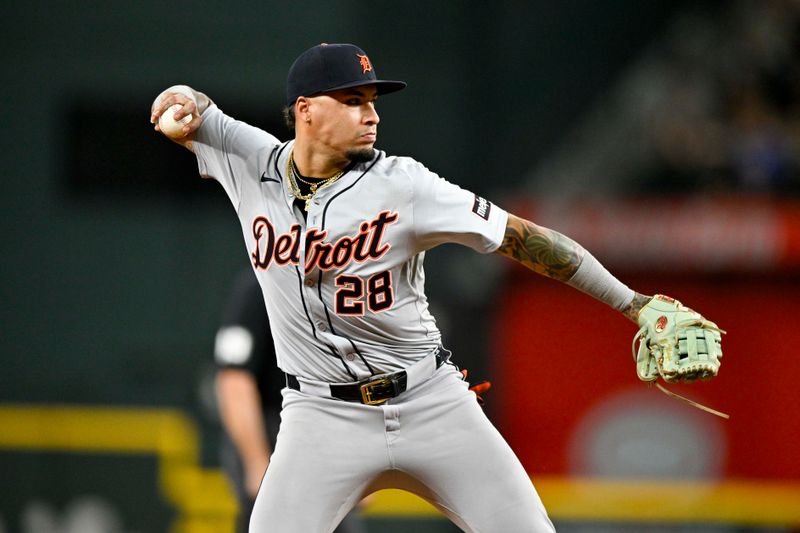 Jun 3, 2024; Arlington, Texas, USA; Detroit Tigers shortstop Javier Baez (28) throws to first base during the fourth inning against the Texas Rangers at Globe Life Field. Mandatory Credit: Jerome Miron-USA TODAY Sports