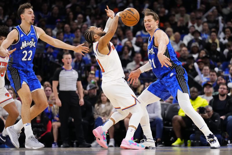 ORLANDO, FLORIDA - FEBRUARY 14: Moritz Wagner #21 of the Orlando Magic steals the ball from Jalen Brunson #11 of the New York Knicks during the third quarter at Kia Center on February 14, 2024 in Orlando, Florida. NOTE TO USER: User expressly acknowledges and agrees that, by downloading and or using this photograph, user is consenting to the terms and conditions of the Getty Images License Agreement. (Photo by Rich Storry/Getty Images)