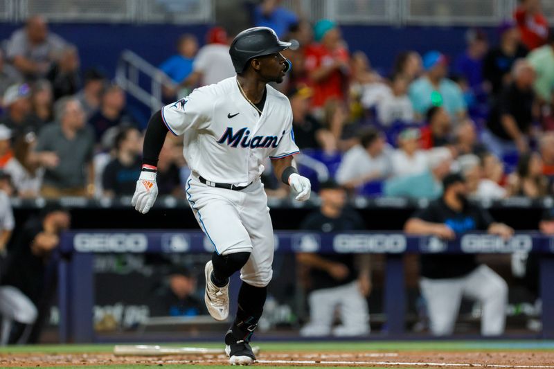 Jun 25, 2023; Miami, Florida, USA; Miami Marlins center fielder Jonathan Davis (49) watches after hitting a home run against the Pittsburgh Pirates during the third inning at loanDepot Park. Mandatory Credit: Sam Navarro-USA TODAY Sports