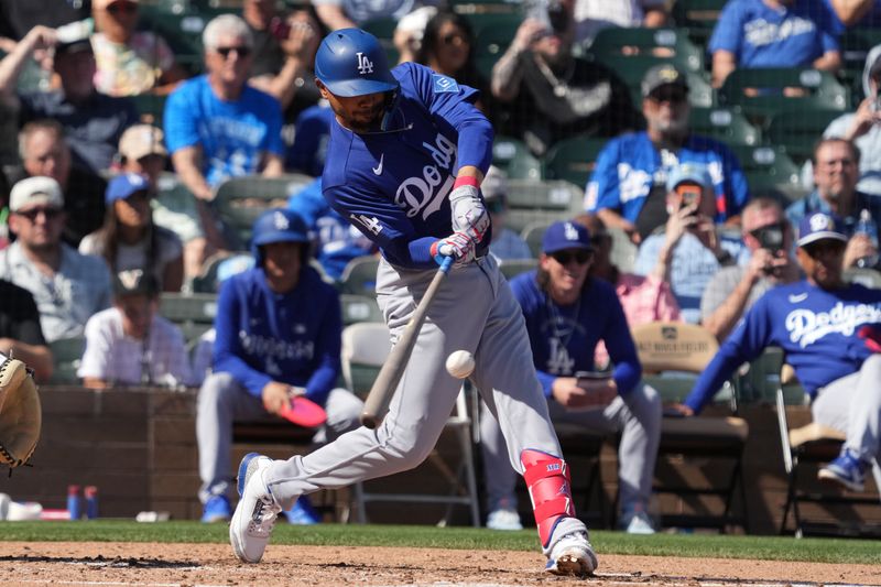 Mar 2, 2026; Salt River Pima-Maricopa, Arizona, USA; Los Angeles Dodgers shortstop Mookie Betts (50) hits against the Colorado Rockies in the third inning at Salt River Fields at Talking Stick. Mandatory Credit: Rick Scuteri-Imagn Images