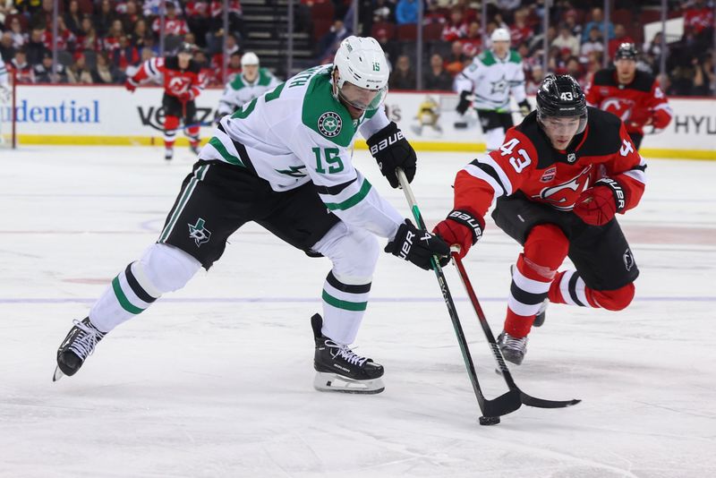 Jan 20, 2024; Newark, New Jersey, USA; Dallas Stars center Craig Smith (15) skates with the puck while being defended by New Jersey Devils defenseman Luke Hughes (43) during the third period at Prudential Center. Mandatory Credit: Ed Mulholland-USA TODAY Sports