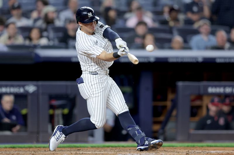 Jun 3, 2025; Bronx, New York, USA; New York Yankees shortstop Anthony Volpe (11) hits a solo home run against the Cleveland Guardians during the seventh inning at Yankee Stadium. Mandatory Credit: Brad Penner-Imagn Images