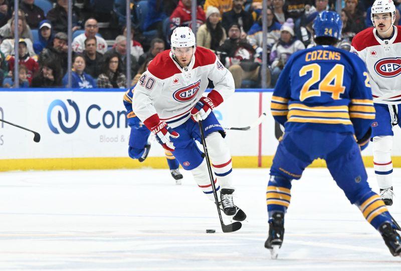 Nov 11, 2024; Buffalo, New York, USA; Montreal Canadiens right wing Joel Armia (40) tries to get past Buffalo Sabres center Dylan Cozens (24) in the first period at KeyBank Center. Mandatory Credit: Mark Konezny-Imagn Images