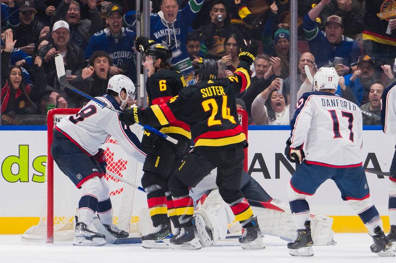 Jan 27, 2024; Vancouver, British Columbia, CAN; Columbus Blue Jackets defenseman Damon Severson (78) and forward Justin Danforth (17) watch as Vancouver Canucks forward Pius Suter (24) and forward Brock Boeser (6) celebrate Baoer s third goal of the game in the third period at Rogers Arena. Canucks won 5-4 in overtime. Mandatory Credit: Bob Frid-USA TODAY Sports