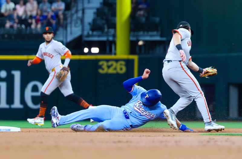 Jun 9, 2024; Arlington, Texas, USA; Texas Rangers second base Marcus Semien (2) steals second base ahead of the tag by San Francisco Giants third baseman Brett Wisely (0) during the first inning at Globe Life Field. Mandatory Credit: Kevin Jairaj-USA TODAY Sports