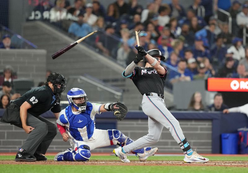 Sep 27, 2024; Toronto, Ontario, CAN; Miami Marlins left fielder Griffin Conine (56) hits broken bat two run RBI single against the Toronto Blue Jays during the fourth inning at Rogers Centre. Mandatory Credit: Nick Turchiaro-Imagn Images