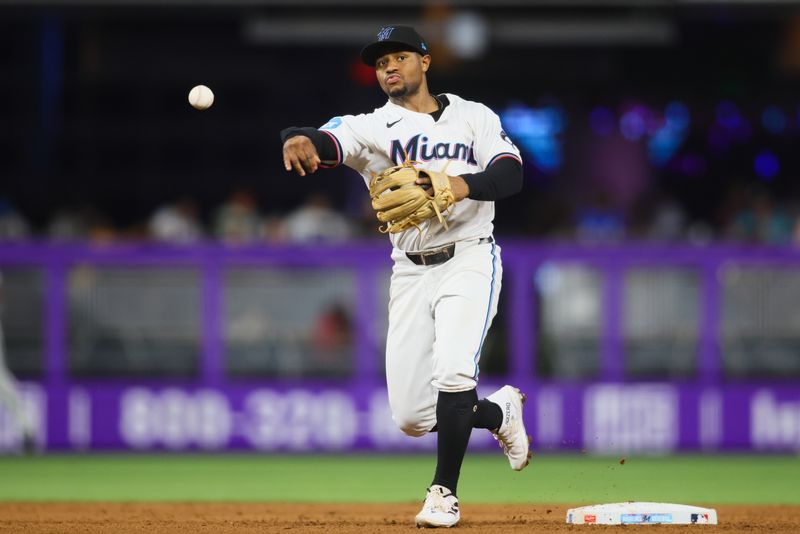 Aug 20, 2024; Miami, Florida, USA; Miami Marlins shortstop Xavier Edwards (63) turns a double play against the Arizona Diamondbacks during the sixth inning at loanDepot Park. Mandatory Credit: Sam Navarro-USA TODAY Sports