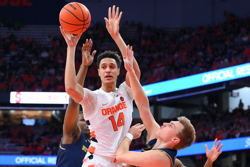 Jan 14, 2023; Syracuse, New York, USA; Syracuse Orange center Jesse Edwards (14) passes the ball against the Notre Dame Fighting Irish during the first half at the JMA Wireless Dome. Mandatory Credit: Rich Barnes-USA TODAY Sports