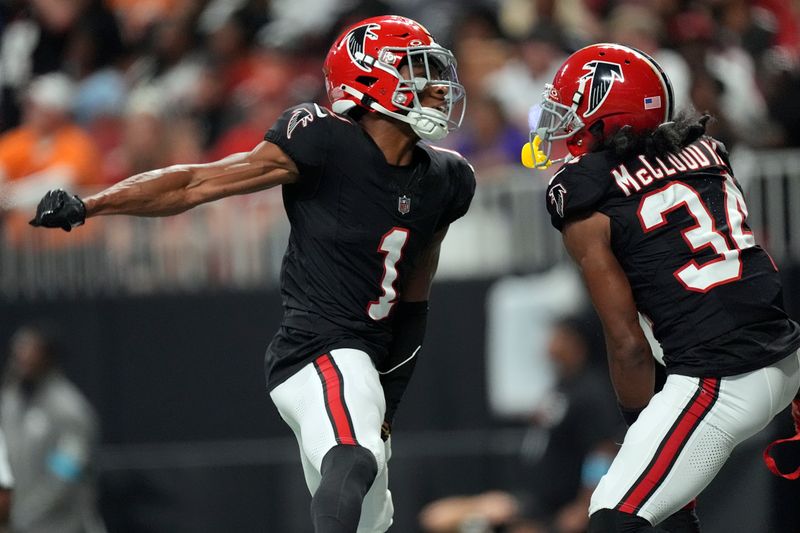 Atlanta Falcons wide receiver Darnell Mooney (1) celebrates with wide receiver Ray-Ray McCloud III (34) after Mooney caught a touchdown pass against the Tampa Bay Buccaneers during the first half of an NFL football game Thursday, Oct. 3, 2024, in Atlanta. (AP Photo/John Bazemore)