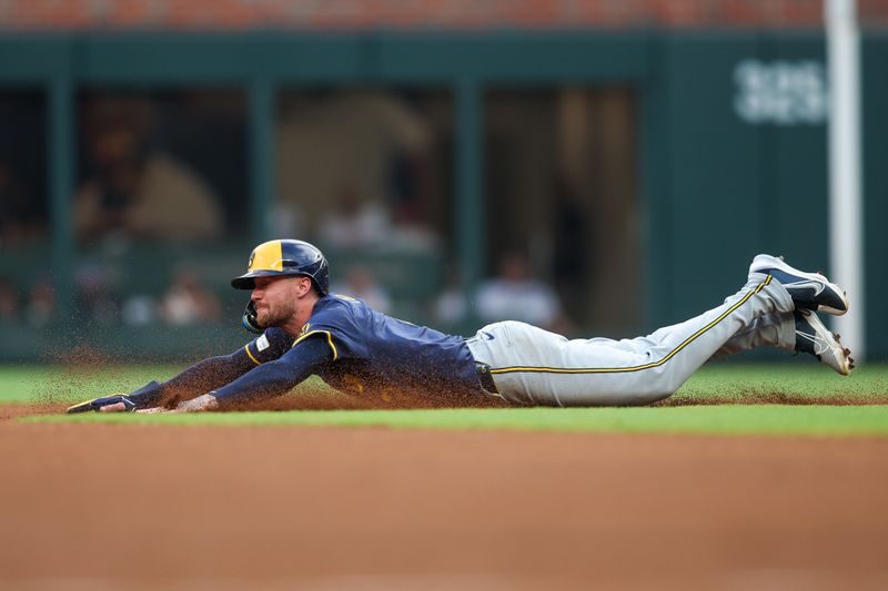 Aug 6, 2024; Atlanta, Georgia, USA; Milwaukee Brewers second baseman Brice Turang (2) slides into second base against the Atlanta Braves in the first inning at Truist Park. Mandatory Credit: Brett Davis-USA TODAY Sports