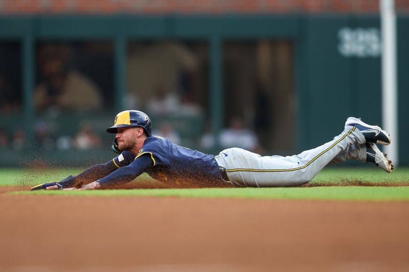 Aug 6, 2024; Atlanta, Georgia, USA; Milwaukee Brewers second baseman Brice Turang (2) slides into second base against the Atlanta Braves in the first inning at Truist Park. Mandatory Credit: Brett Davis-USA TODAY Sports