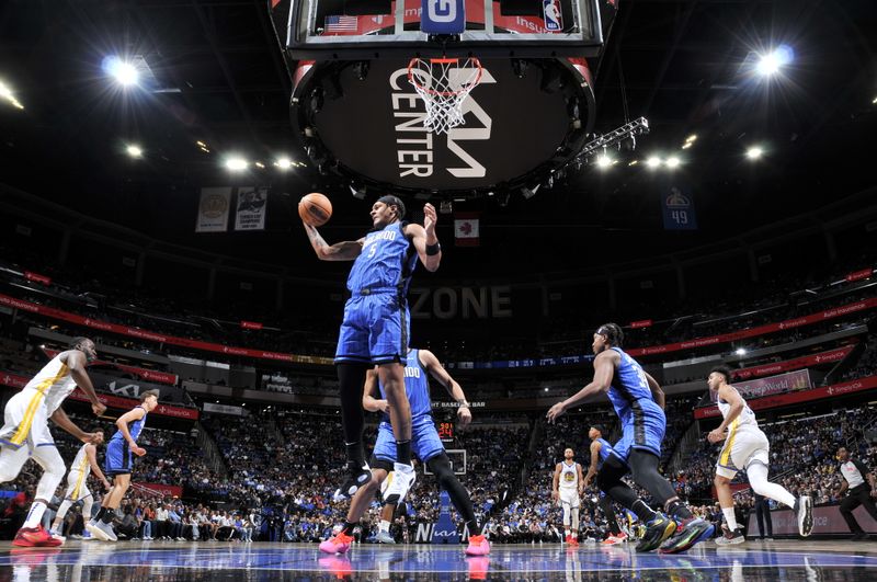 ORLANDO, FL - MARCH 27: Paolo Banchero #5 of the Orlando Magic rebounds the ball during the game against the Golden State Warriors on March 27, 2024 at Amway Center in Orlando, Florida. NOTE TO USER: User expressly acknowledges and agrees that, by downloading and or using this photograph, User is consenting to the terms and conditions of the Getty Images License Agreement. Mandatory Copyright Notice: Copyright 2024 NBAE (Photo by Fernando Medina/NBAE via Getty Images)