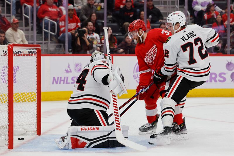 Nov 30, 2023; Detroit, Michigan, USA; Detroit Red Wings left wing J.T. Compher (37) scores a goal on Chicago Blackhawks goaltender Petr Mrazek (34) in the second period at Little Caesars Arena. Mandatory Credit: Rick Osentoski-USA TODAY Sports