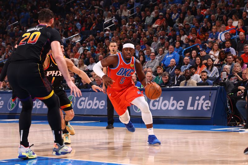 OKLAHOMA CITY, OK - MARCH 29: Luguentz Dort #5 of the Oklahoma City Thunder handles the ball during the game against the Phoenix Suns on March 29, 2024 at Paycom Arena in Oklahoma City, Oklahoma. NOTE TO USER: User expressly acknowledges and agrees that, by downloading and or using this photograph, User is consenting to the terms and conditions of the Getty Images License Agreement. Mandatory Copyright Notice: Copyright 2024 NBAE (Photo by Zach Beeker/NBAE via Getty Images)