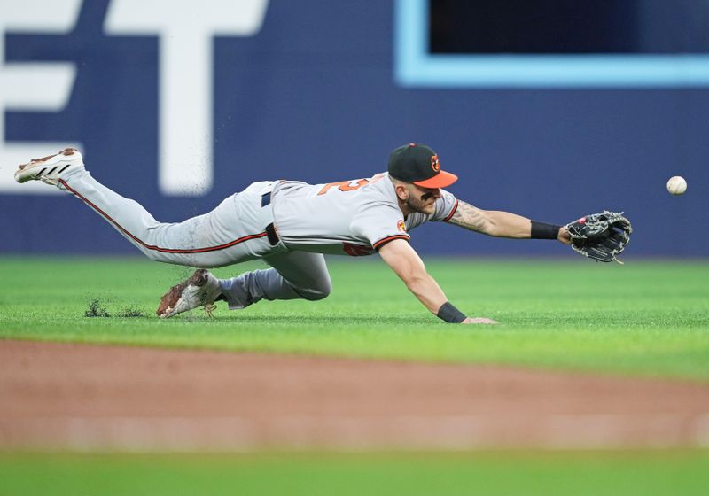 Jun 3, 2024; Toronto, Ontario, CAN; Baltimore Orioles second baseman Connor Norby (12) dives for a ground ball against theToronto Blue Jays during the sixth inning at Rogers Centre. Mandatory Credit: Nick Turchiaro-USA TODAY Sports