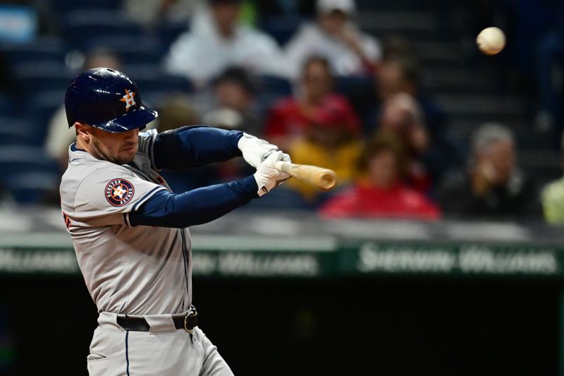 Sep 27, 2024; Cleveland, Ohio, USA; Houston Astros third baseman Alex Bregman (2) hits a sacrifice fly during the first inning against the Cleveland Guardians at Progressive Field. Mandatory Credit: Ken Blaze-Imagn Images