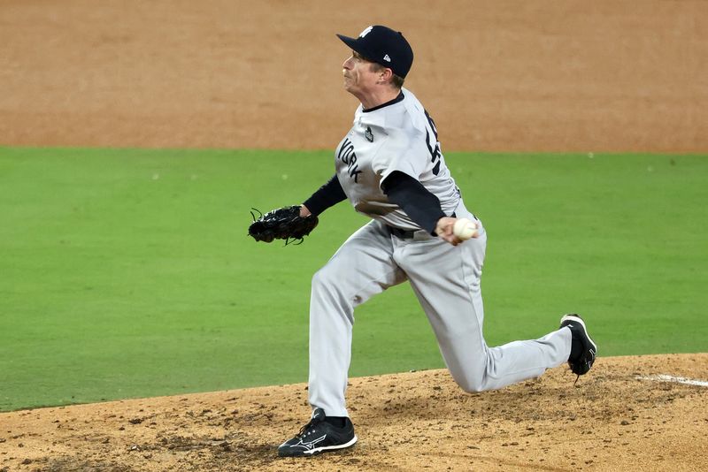 Oct 26, 2024; Los Angeles, California, USA; New York Yankees pitcher Tim Hill (54) throws a pitch against the Los Angeles Dodgers in the sixth inning for game two of the 2024 MLB World Series at Dodger Stadium. Mandatory Credit: Kiyoshi Mio-Imagn Images