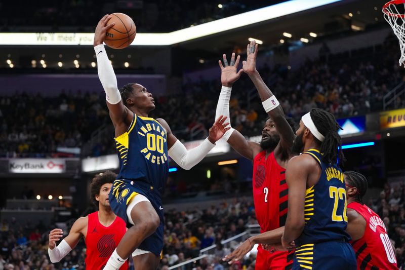 INDIANAPOLIS, INDIANA - NOVEMBER 27: Bennedict Mathurin #00 of the Indiana Pacers attempts a shot while being guarded by Deandre Ayton #2 of the Portland Trail Blazers in the fourth quarter at Gainbridge Fieldhouse on November 27, 2023 in Indianapolis, Indiana. NOTE TO USER: User expressly acknowledges and agrees that, by downloading and or using this photograph, User is consenting to the terms and conditions of the Getty Images License Agreement. (Photo by Dylan Buell/Getty Images)