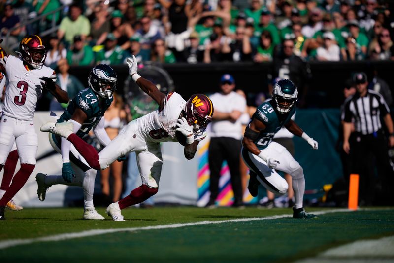 Washington Commanders running back Brian Robinson Jr. (8) runs for a touchdown during the second half of an NFL football game against the Philadelphia Eagles on Sunday, Oct. 1, 2023, in Philadelphia. (AP Photo/Matt Slocum)