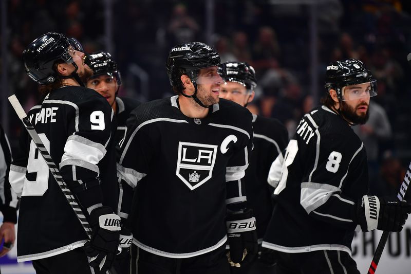 Mar 16, 2023; Los Angeles, California, USA; Los Angeles Kings center Anze Kopitar (11) celebrates his goal scored against the Columbus Blue Jackets with right wing Adrian Kempe (9) and defenseman Drew Doughty (8) during the second period at Crypto.com Arena. Mandatory Credit: Gary A. Vasquez-USA TODAY Sports