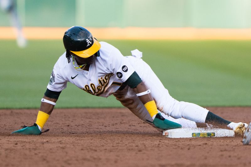 Jun 14, 2023; Oakland, California, USA;  Oakland Athletics center fielder Esteury Ruiz (1) slides into second during the third inning against the Tampa Bay Rays at Oakland-Alameda County Coliseum. Mandatory Credit: Stan Szeto-USA TODAY Sports