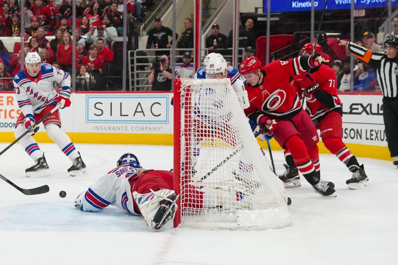Dec 29, 2025; Raleigh, North Carolina, USA;  New York Rangers goaltender Igor Shesterkin (31) stops the scoring attempt by Carolina Hurricanes right wing Jackson Blake (53) during the first period at Lenovo Center. Mandatory Credit: James Guillory-Imagn Images