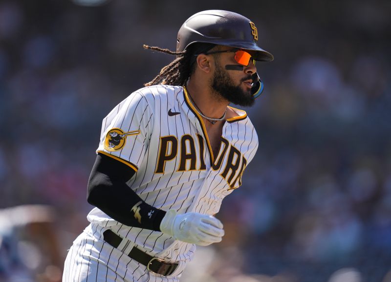 Aug 23, 2023; San Diego, California, USA;  San Diego Padres right fielder Fernando Tatis Jr. (23) hits an RBI single to score first baseman Garrett Cooper (not pictured) against the Miami Marlins during the seventh inning at Petco Park. Mandatory Credit: Ray Acevedo-USA TODAY Sports