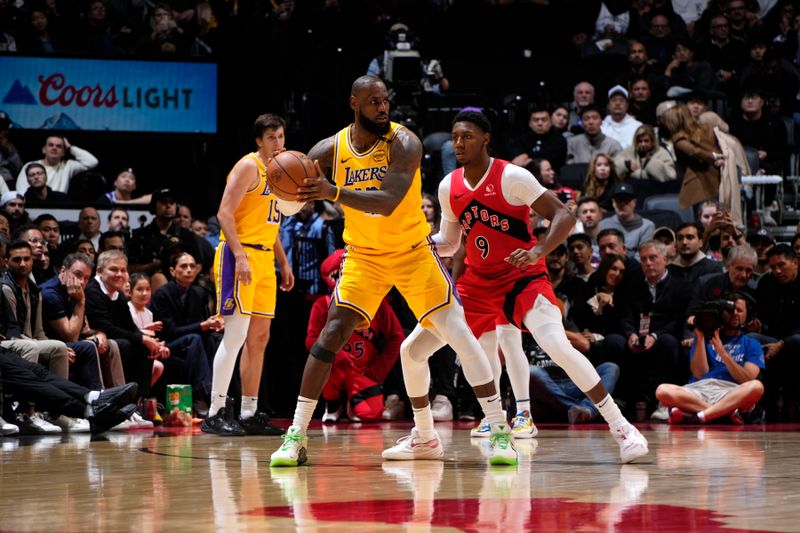 TORONTO, CANADA - NOVEMBER 1: LeBron James #23 of the Los Angeles Lakers handles the ball during the game against the Toronto Raptors on November 1, 2024 at the Scotiabank Arena in Toronto, Ontario, Canada.  NOTE TO USER: User expressly acknowledges and agrees that, by downloading and or using this Photograph, user is consenting to the terms and conditions of the Getty Images License Agreement.  Mandatory Copyright Notice: Copyright 2024 NBAE (Photo by Mark Blinch/NBAE via Getty Images)