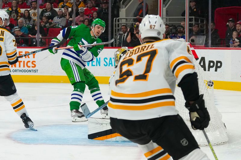 Mar 26, 2023; Raleigh, North Carolina, USA;  Carolina Hurricanes center Sebastian Aho (20) scores a goal against the Boston Bruins during the third period at PNC Arena. Mandatory Credit: James Guillory-USA TODAY Sports