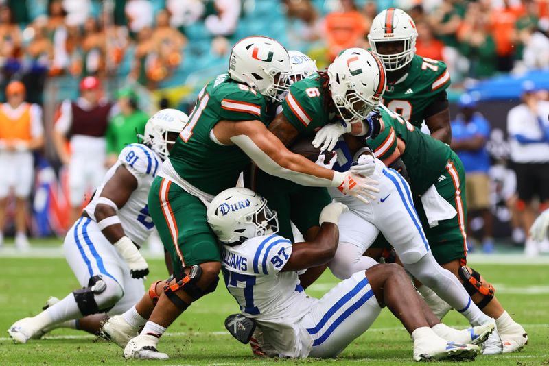 Nov 2, 2024; Miami Gardens, Florida, USA; Miami Hurricanes running back Damien Martinez (6) runs with the football against the Duke Blue Devils during the first quarter at Hard Rock Stadium. Mandatory Credit: Sam Navarro-Imagn Images