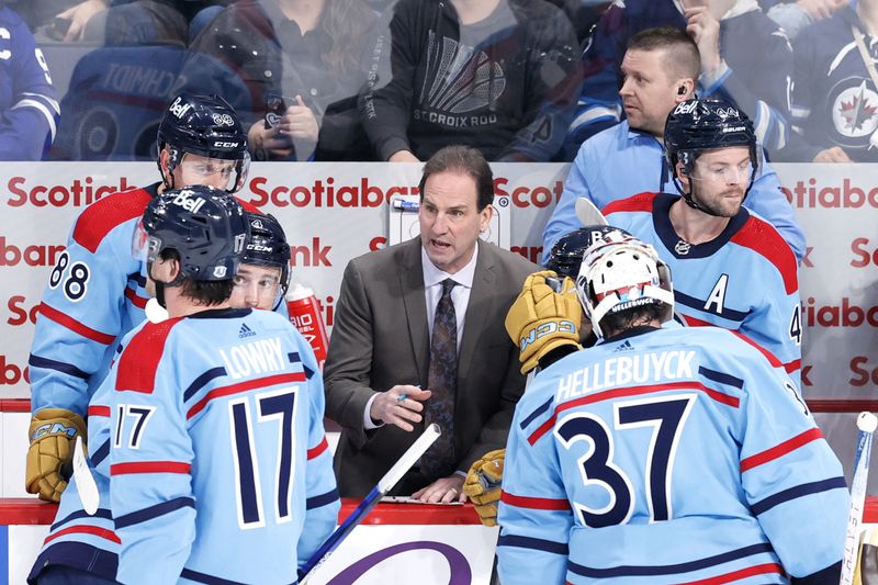 Jan 27, 2024; Winnipeg, Manitoba, CAN; Winnipeg Jets assistant coach talks over a play in the third period against the Toronto Maple Leafs at Canada Life Centre. Mandatory Credit: James Carey Lauder-USA TODAY Sports