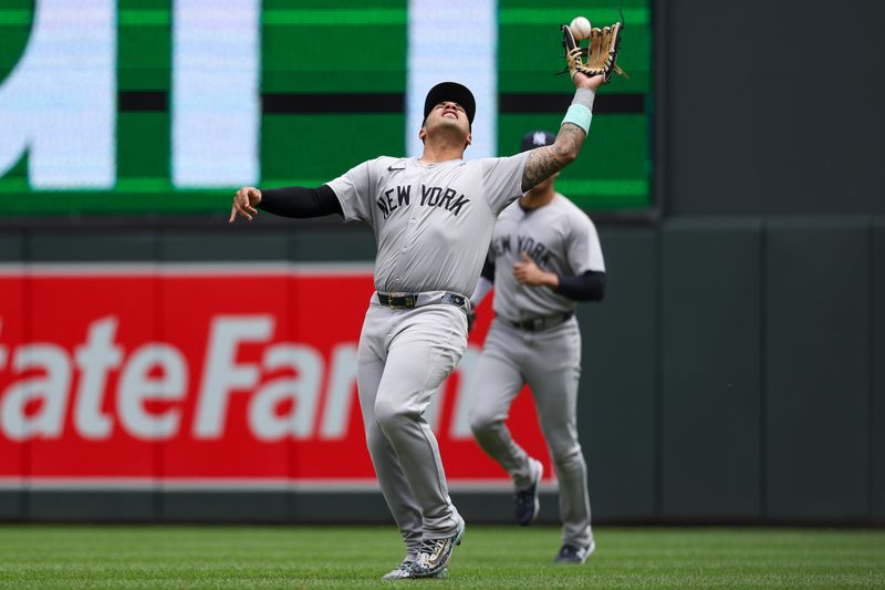 May 16, 2024; Minneapolis, Minnesota, USA; New York Yankees second baseman Gleyber Torres (25) catches a fly ball hit by Minnesota Twins Carlos Santana (30) during the fourth inning at Target Field. Mandatory Credit: Matt Krohn-USA TODAY Sports