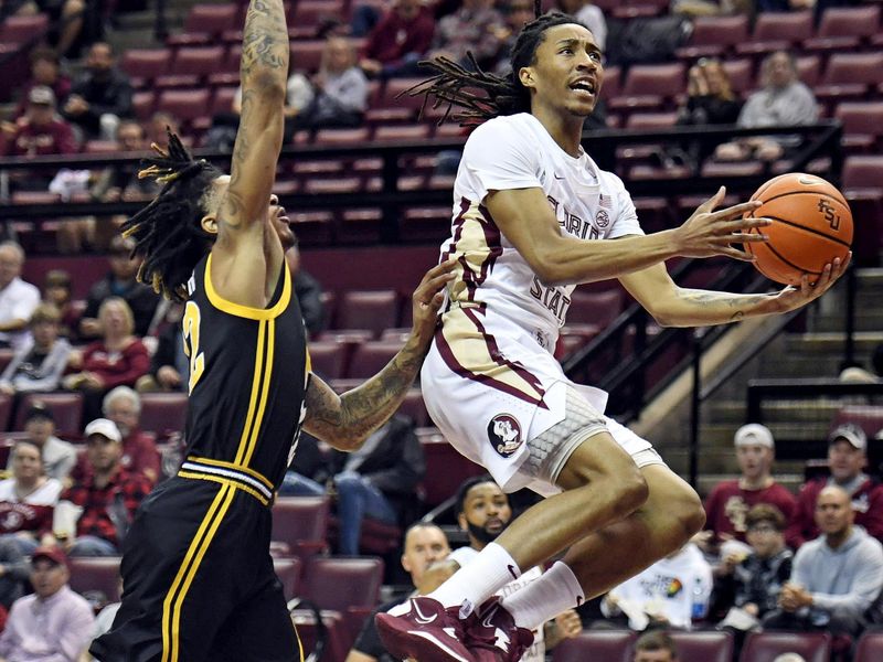 Feb 11, 2023; Tallahassee, Florida, USA; Florida State Seminoles guard Caleb Mills (4) goes up for a shot during the first half against the Pittsburgh Panthers at Donald L. Tucker Center. Mandatory Credit: Melina Myers-USA TODAY Sports