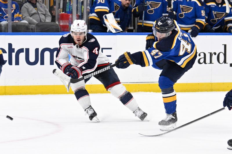 Jan 30, 2024; St. Louis, Missouri, USA; St. Louis Blues defenseman Torey Krug (47) takes a shot against Columbus Blue Jackets center Cole Sillinger (4) during the second period at Enterprise Center. Mandatory Credit: Jeff Le-USA TODAY Sports