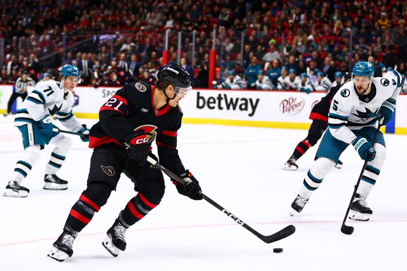Mar 15, 2026; Ottawa, Ontario, CAN; Ottawa Senators center Nick Cousins (21) skates with the puck against San Jose Sharks defenseman Vincent Desharnais (5) during the first period at Canadian Tire Centre. Mandatory Credit: Keito Newman-Imagn Images