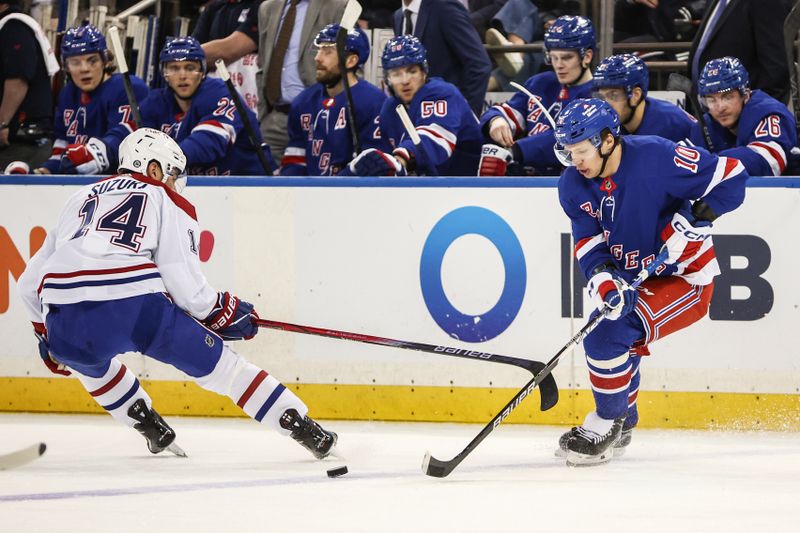 Apr 7, 2024; New York, New York, USA;  Montreal Canadiens center Nick Suzuki (14) and New York Rangers left wing Artemi Panarin (10) battle for control of the puck in the first period at Madison Square Garden. Mandatory Credit: Wendell Cruz-USA TODAY Sports