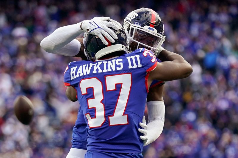 New York Giants cornerback Tre Hawkins III (37) and safety Jason Pinnock react during the fourth quarter of an NFL football game against the Washington Commanders, Sunday, Oct. 22, 2023, in East Rutherford, N.J. (AP Photo/Seth Wenig)