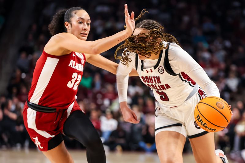 Feb 22, 2024; Columbia, South Carolina, USA; South Carolina Gamecocks guard Tessa Johnson (5) drives around Alabama Crimson Tide guard Aaliyah Nye (32) in the first half at Colonial Life Arena. Mandatory Credit: Jeff Blake-USA TODAY Sports