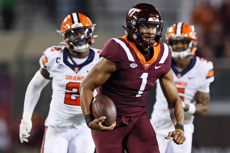 Oct 26, 2023; Blacksburg, Virginia, USA; Virginia Tech Hokies quarterback Kyron Drones (1) runs the ball against Syracuse Orange linebacker Marlowe Wax (2) during the second quarter at Lane Stadium. Mandatory Credit: Peter Casey-USA TODAY Sports