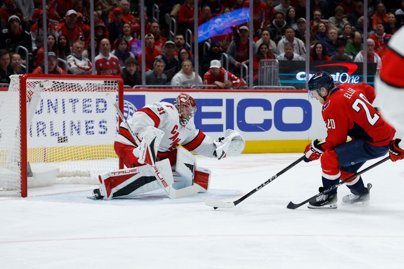 Apr 10, 2025; Washington, District of Columbia, USA; Carolina Hurricanes goaltender Frederik Andersen (31) makes a save on Washington Capitals center Lars Eller (20) in the first period at Capital One Arena. Mandatory Credit: Geoff Burke-Imagn Images