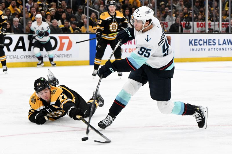 Nov 3, 2024; Boston, Massachusetts, USA; Boston Bruins defenseman Charlie McAvoy (73) defends Seattle Kraken left wing Andre Burakovsky (95) during the second period at the TD Garden. Mandatory Credit: Brian Fluharty-Imagn Images