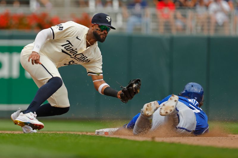 Aug 14, 2024; Minneapolis, Minnesota, USA; Minnesota Twins shortstop Willi Castro (50) tags out Kansas City Royals shortstop Bobby Witt (7) on an attempted steal in the ninth inning at Target Field. Mandatory Credit: Bruce Kluckhohn-USA TODAY Sports