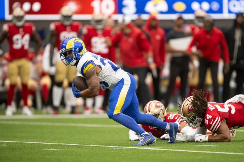 Los Angeles Rams running back Kyren Williams (23) runs with the ball past San Francisco 49ers linebacker Fred Warner (54) and cornerback Isaiah Oliver (26) during an NFL football game, Sunday, Sept. 17, 2023, in Inglewood, Calif. (AP Photo/Kyusung Gong)