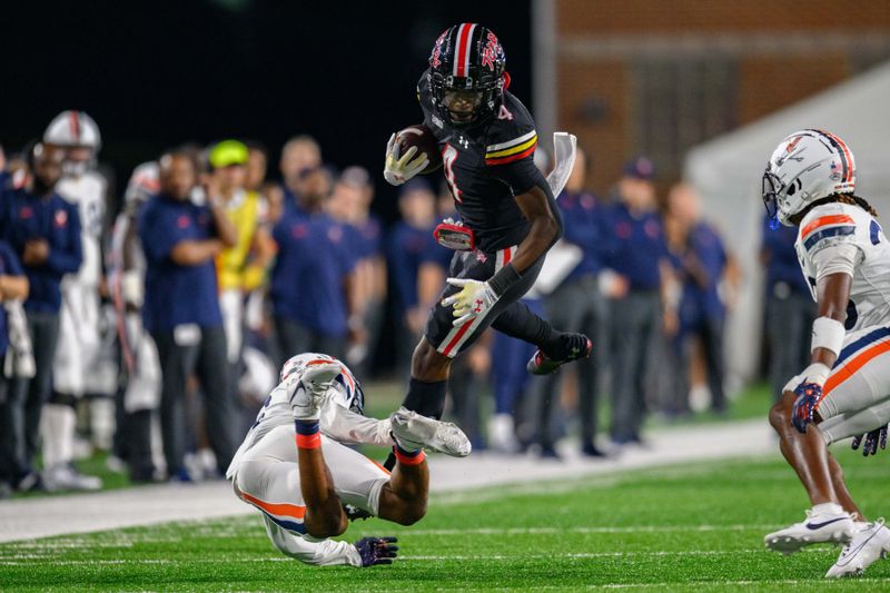 Sep 15, 2023; College Park, Maryland, USA; Maryland Terrapins wide receiver Shaleak Knotts (4) is tackled during the second quarter against the Virginia Cavaliers at SECU Stadium. Mandatory Credit: Reggie Hildred-USA TODAY Sports