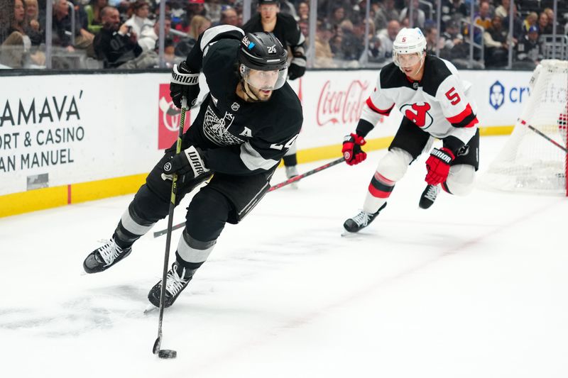 Nov 1, 2025; Los Angeles, California, USA; Los Angeles Kings center Phillip Danault (24) handles the puck against the New Jersey Devils in the second period at Crypto.com Arena. Mandatory Credit: Kirby Lee-Imagn Images