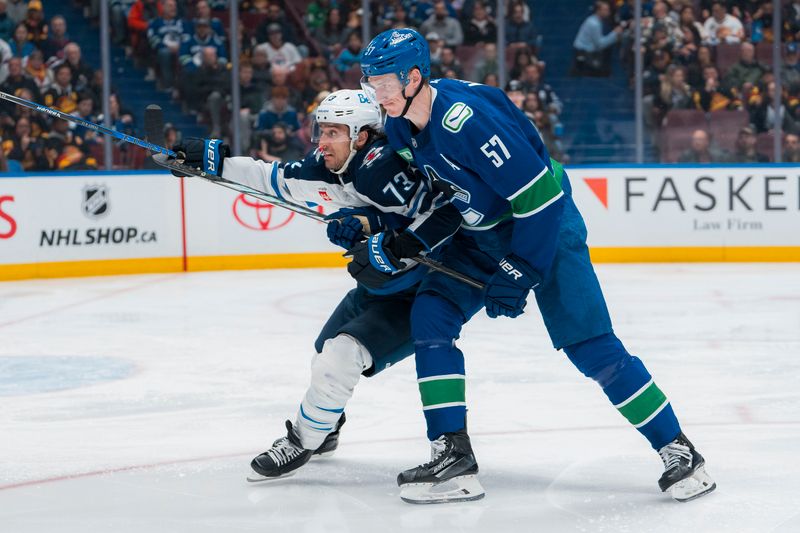 Mar 18, 2025; Vancouver, British Columbia, CAN; Winnipeg Jets forward Brandon Tanev (73) battles with Vancouver Canucks defenseman Tyler Myers (57) in the third period at Rogers Arena. Mandatory Credit: Bob Frid-Imagn Images