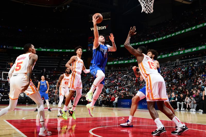 ATLANTA, GA - JANUARY 26: Luka Doncic #77 of the Dallas Mavericks drives to the basket during the game against the Atlanta Hawks on January 26, 2024 at State Farm Arena in Atlanta, Georgia.  NOTE TO USER: User expressly acknowledges and agrees that, by downloading and/or using this Photograph, user is consenting to the terms and conditions of the Getty Images License Agreement. Mandatory Copyright Notice: Copyright 2024 NBAE (Photo by Scott Cunningham/NBAE via Getty Images)