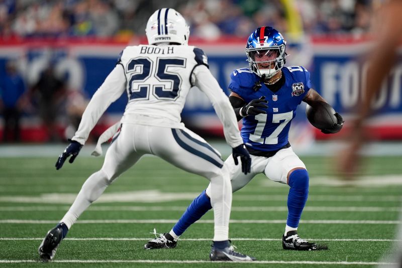 New York Giants wide receiver Wan'Dale Robinson (17) carries the ball against Dallas Cowboys cornerback Andrew Booth Jr. (25) during the first quarter of an NFL football game, Thursday, Sept. 26, 2024, in East Rutherford, N.J. (AP Photo/Bryan Woolston)