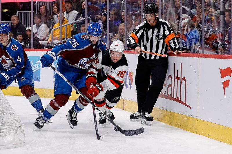 Nov 7, 2023; Denver, Colorado, USA; Colorado Avalanche center Ondrej Pavel (26) and New Jersey Devils left wing Ondrej Palat (18) battle for the puck in the third period at Ball Arena. Mandatory Credit: Isaiah J. Downing-USA TODAY Sports